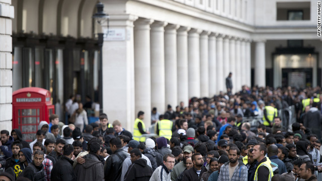 Customers wait outside the Covent Garden in London on Friday. Throngs of shoppers lined up outside Apple stores in Sydney, Tokyo, London, Paris and Munich, among other cities where the phone went on sale.