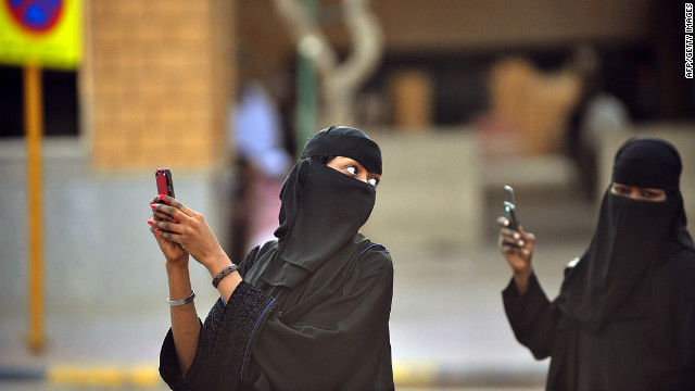 These Saudi women are taking photos with their mobile phones after the end of a prayer performed on the first day of Eid al-Fitr in the great mosque in the old City of Riyadh to mark the end of the holy fasting month of Ramadan. 