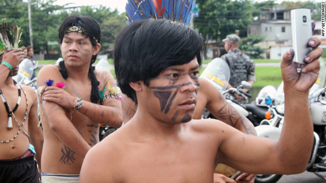 A native Brazilian takes a picture with his mobile phone of the indigenous groups at the Rio 2012 environmental summit in in Rio de Janeiro. 