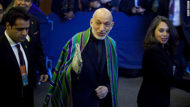 Afghan President Hamid Karzai, center, arrives on Tuesday.