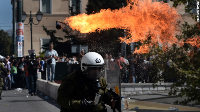 Firebombs explode in front of riot police Wednesday.