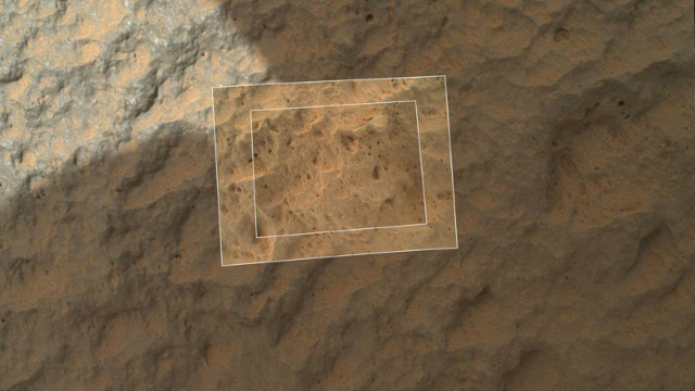 This image combines photographs taken by the rover's Mars Hand Lens Imager at three distances from the first Martian rock that NASA's Curiosity rover touched with its arm. The images reveal that the target rock has a relatively smooth, gray surface with some glinty facets reflecting sunlight and reddish dust collecting in recesses in the rock.