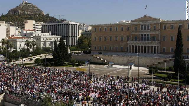 Demonstrators march by the parliament during the strike on Wednesday.