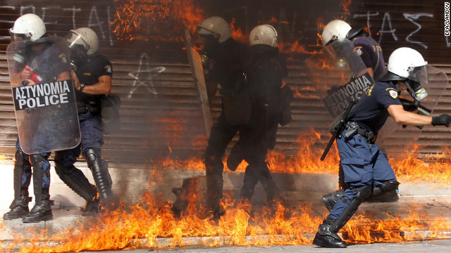 Riot police are surrounded by flames during violent clashes in Athens on Wednesday.