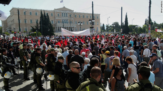 Thousands shout slogans in front of the Greek parliament during a general strike in Athens on Wednesday. The first nationwide strike since Greece's new coalition government was formed in June was called by Greece's two biggest labor unions.