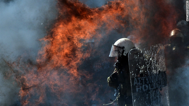 A fire bomb explodes near a riot police squad on Wednesday.