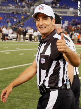 Umpire Randy Tabler gives a thumbs up as the regular officials take the field Thursday for the first time this season.