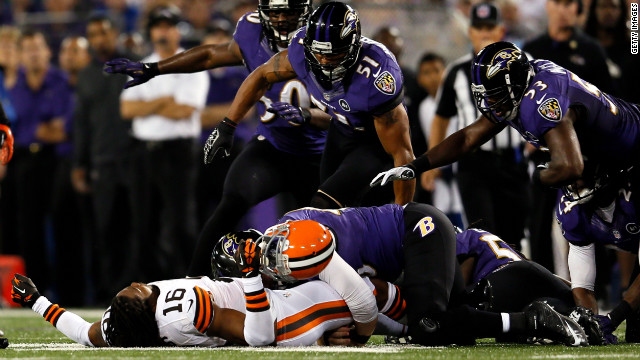 Wide receiver Joshus Cribbs of the Cleveland Browns lies unconscious on the ground after getting hit by linebacker Dannell Ellerbe in the first quarter Thursday.