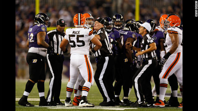 Umpire Bill Schuster, center, and referee Gene Steratore break up a fight between Cleveland Browns and Baltimore Ravens players during the game on Thursday.