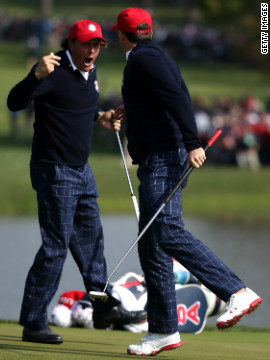 Phil Mickelson and Keegan Bradley celebrate on the 15th green after defeating Luke Donald and Sergio Garcia during the morning foursome matches on Friday.