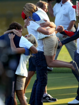 Phil Mickelson and Keegan Bradley celebrate on the 17th green with Amy Mickelson and Jillian Stacey after defeating Rory McIlroy and Graeme McDowell 2 and 1 during the afternoon four-ball matches on Friday.