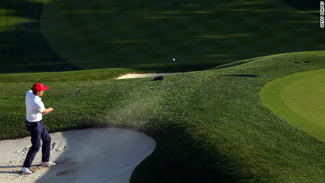 Keegan Bradley of the USA hits out of the bunker on the 16th green after defeating Rory McIlroy and Graeme McDowell on Friday, September 28. 