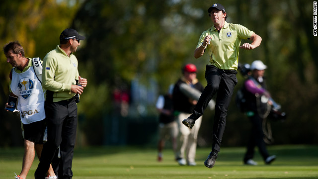 Rory McIlroy of Northern Ireland, right, jumps in the air while speaking with teammate Sergio Garcia of Spain, ssecond left, on the 10th fairway on Friday.