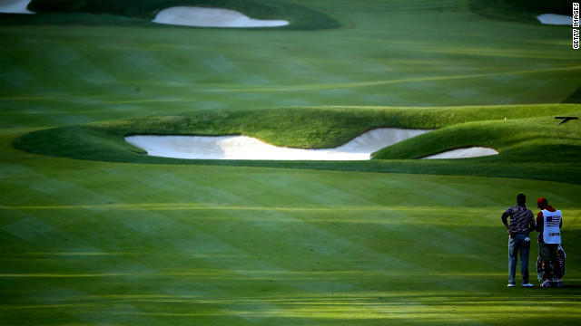 Webb Simpson of the United States waits in the fifth fairway with his caddie Paul Tesori on Saturday.