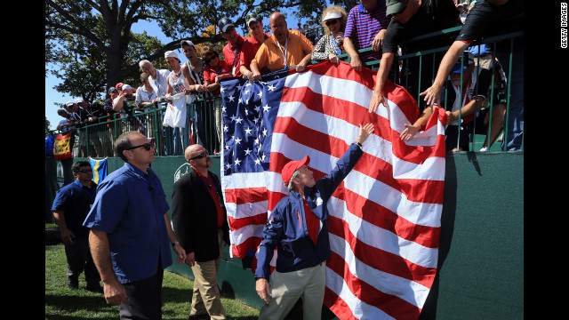 Bush reaches to shake the hands of spectators at the tournament Saturday.