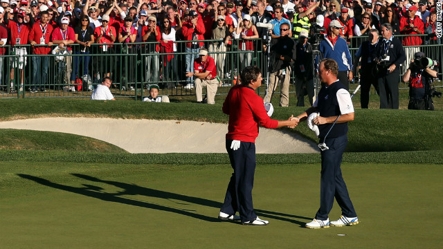 Jason Dufner of the United States, left, shakes hands with Peter Hanson on the 18th green after Dufner defeated Hanson.