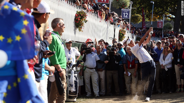 Ian Poulter of Europe hits a shot from the rough on the 18th hole Sunday.