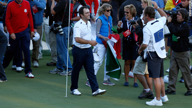 Europe's Francesco Molinari celebrates with his caddie, Jason Hempleman, on the 18th green Sunday after his match with Tiger Woods.