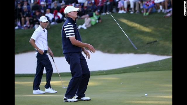 Steve Stricker of the United States reacts to a missed putt on the 17th green as Martin Kaymer of Europe looks on during Sunday's competition.