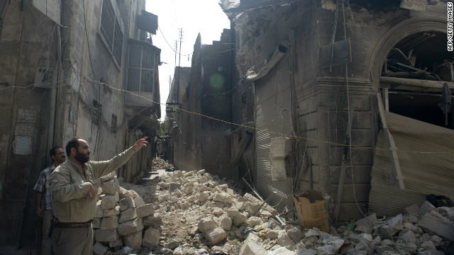 Syrians inspect damages in the old city of Aleppo after the area was shelled by Syrian regime forces on Sunday.