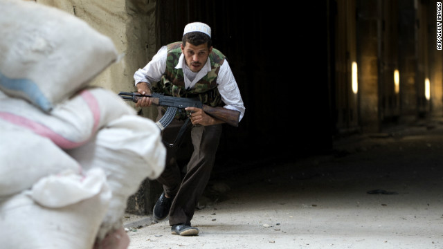 A Syrian rebel ducks for cover during clashes to control the area around the Zacharias mosque in the old city of Aleppo.