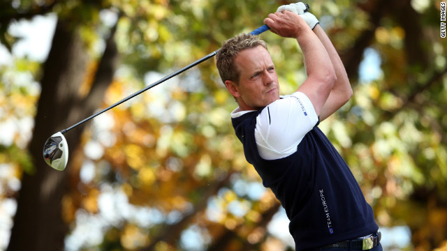 Luke Donald of Europe watches his tee shot on the third hole Sunday.