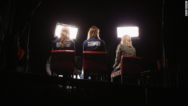 Volunteers sit in for on-air television reporters on Tuesday in preparation for the first presidential debate in the Ritchie Center at the University of Denver.