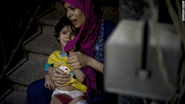 A mother holds her wounded daughter as she waits for treatment at the Dar al-Shifa hospital in the northern city of Aleppo, as fighting in Syria's second largest city continues.