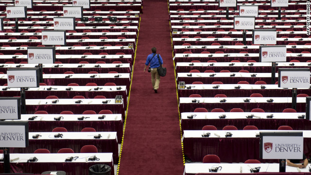 A man walks through the media center as preparations continue on Monday.