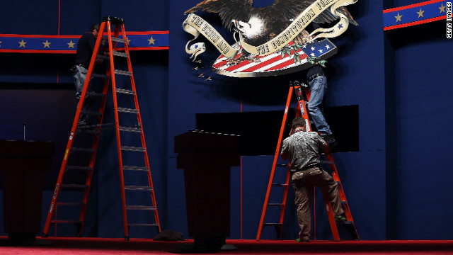 Workers make adjustments to the stage on Tuesday. 