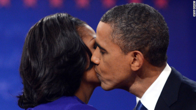 President Obama kisses first lady Michelle Obama after the debate Wednesday. It took place on their 20th wedding anniversary.