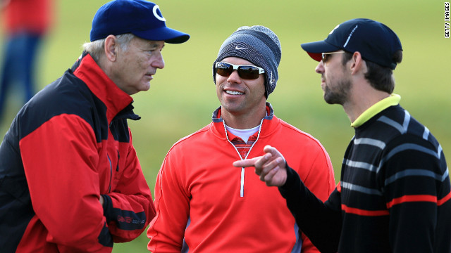 Actor Bill Murray (L) and Olympic swimming legend Michael Phelps (R) chat with English golfer Paul Casey
