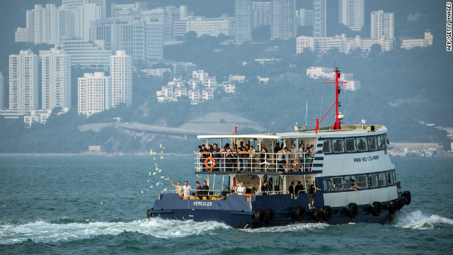 Mourners accompanied by Taoist priests take boats on Thursday, October 4, to go to the scene of the boat collision that killed 38 people off Lamma Island, near Hong Kong, on October 1. They throw paper offerings for the dead into the sea. 