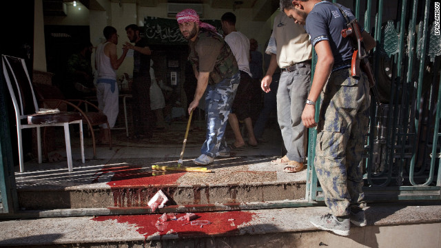 A Dar El Shifa worker cleans the floor outside the hospital in Aleppo on Thursday.