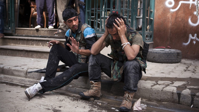 A Free Syrian Army figther cries after one of his friends was injured in fighting with government forces outside the Dar El Shifa hospital on Thursday.