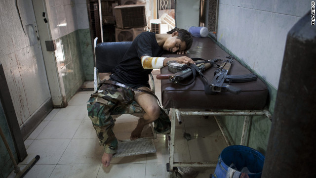 An injured Free Syrian Army fighter rests after receiving treatment at Dar al Shifa hospital in Aleppo on Thursday, October 4.