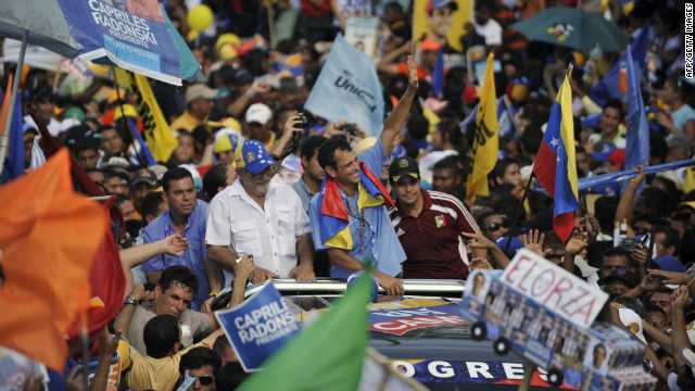 Venezuelan opposition presidential candidate Henrique Capriles Radonski, center, waves to supporters during a campaign rally on Thursday in San Fernando de Apure.