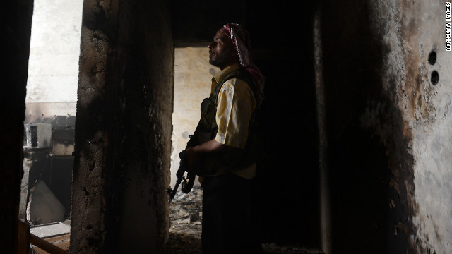 A Syrian rebel takes position during clashes with government forces in Aleppo on Friday.