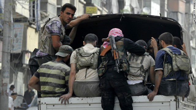 Syrian rebels patrol a neighborhood in Aleppo on Friday, October 5.