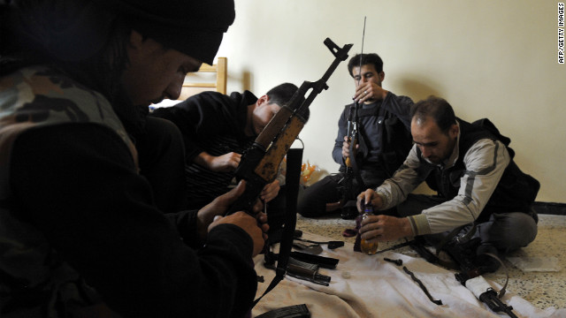 Syrian members of the Al-Saiqa rebel brigade clean weapons on Saturday before going to the front line in Aleppo.
