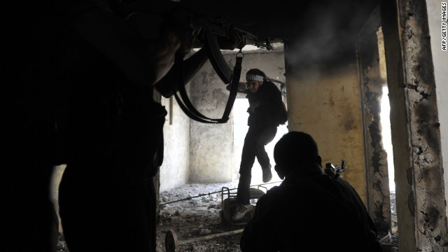 Syrian rebels take up positions inside a building during clashes with government forces in Aleppo on Saturday, October 6. Click through the gallery to view images of the fighting in October. See photographs of the fighting in September.