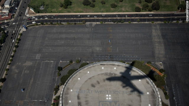 Air Force One leaves a shadow as it passes over the Forum on approach to Los Angeles International Airport on Sunday.