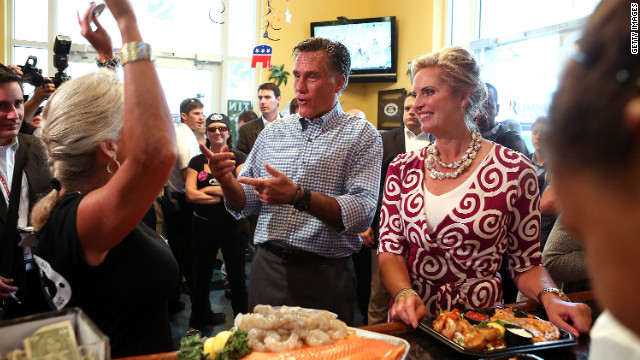 Republican presidential candidate Mitt Romney and his wife, Ann, greet workers at the Tin Fish restaurant following a rally Sunday in Port St. Lucie, Florida.