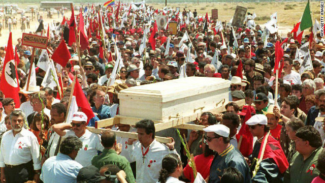 An estimated 25,000 mourners accompany Chavez's pine casket through farmlands to his funeral Mass in Delano, California, on April 29, 1993.