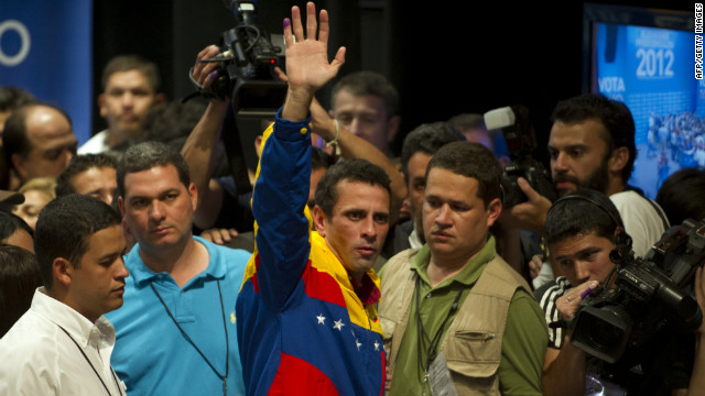 Opposition candidate Henrique Capriles Radonski waves to supporters Sunday night in Caracas after learning of his defeat. During the campaign, he criticized the Chavez administration for inefficiencies, infrastructure shortcomings and corruption.