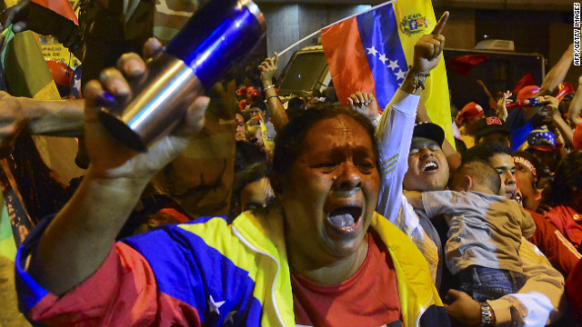 Chavez backers cheer Sunday night as provisional returns show the president won a new six-year term.