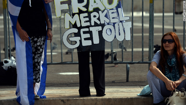 Protesters hold anti-German banners near parliament before the visit of German Chancelor Angela Merkel in Athens.