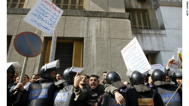 Egyptian riot policemen stop protesters from approaching the parliament building in downtown Cairo during a demonstration in 2011 by people calling for an end to poverty and unemployment.