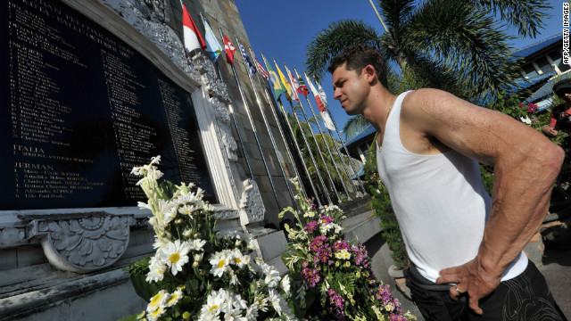 Survivor Phil Britten looks at the names of dead victims at a memorial monument three days before a ceremony to remember those killed. He was just 22 years old and had only been in Bali a few hours when he was caught in the blast and suffered burns to 60% of his body.