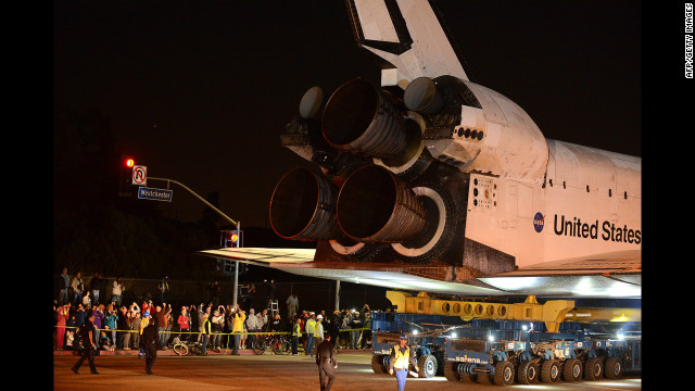 Bystanders watch as Endeavour moves out of the Los Angeles airport and onto a public street.